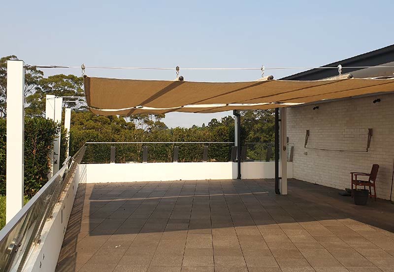 Retractable shade over a timber deck