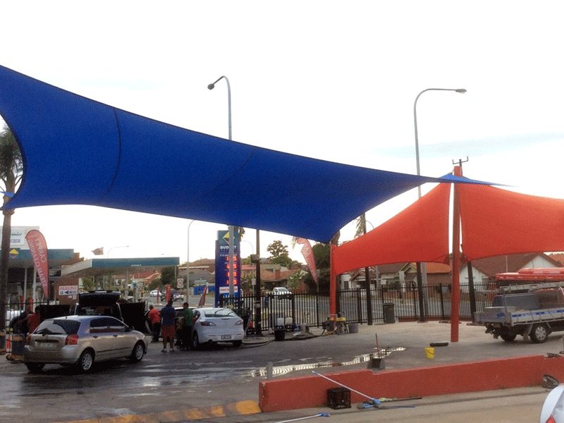 Large blue and red shade sails in Granville
