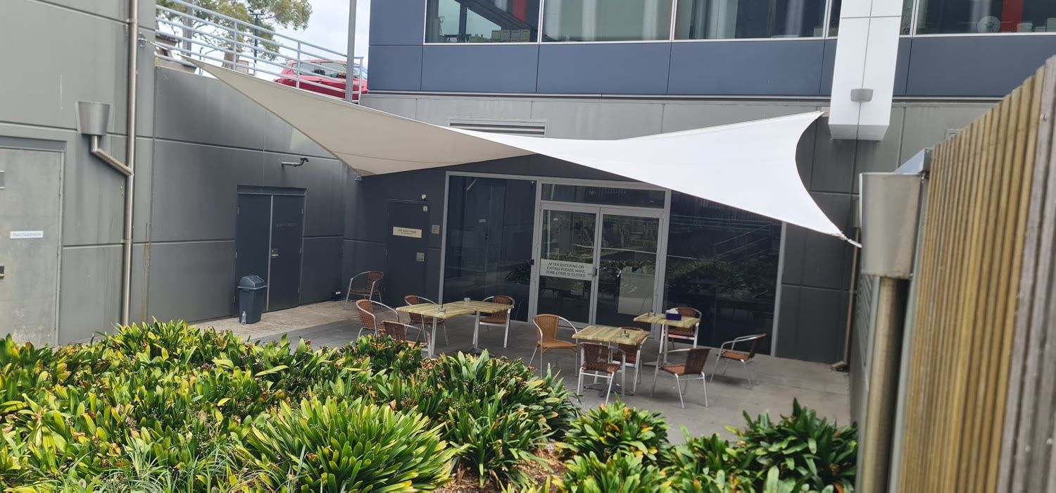 Shade sail over a café courtyard